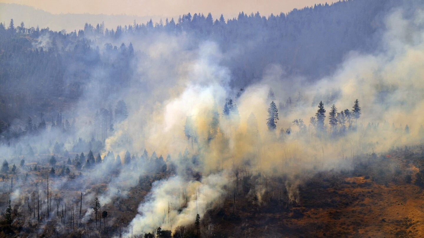 California man defends his home as wildfires push devastation and spread smoke across US West