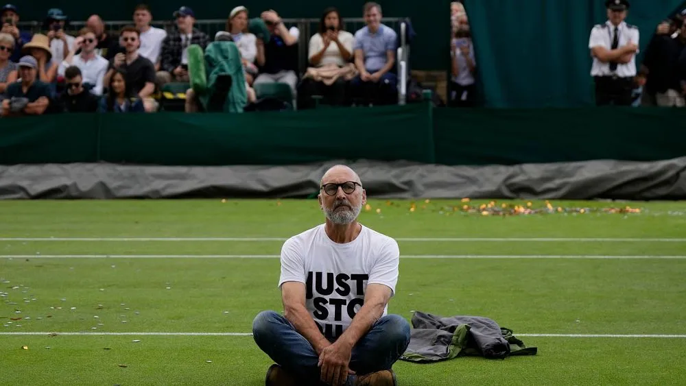 Just Stop Oil protesters storm Wimbledon court and throw confetti